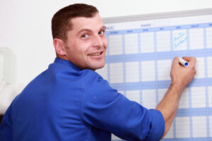 man filling work calendar